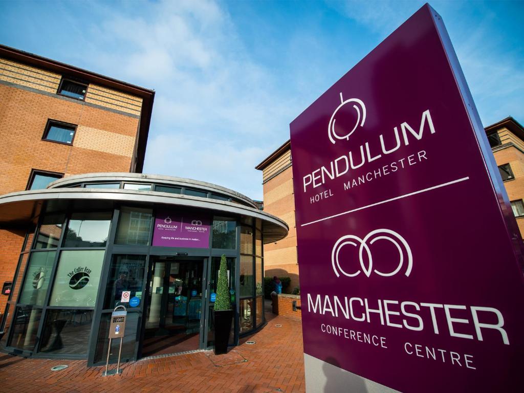 a sign in front of a building at Pendulum Hotel in Manchester