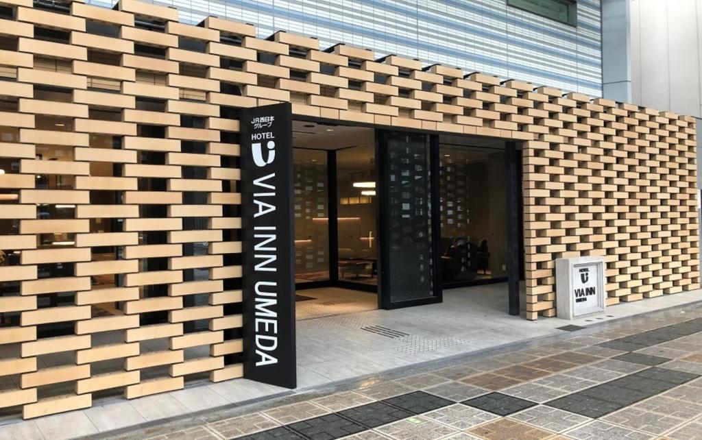 a building with a sign on the side of it at Via Inn Umeda in Osaka