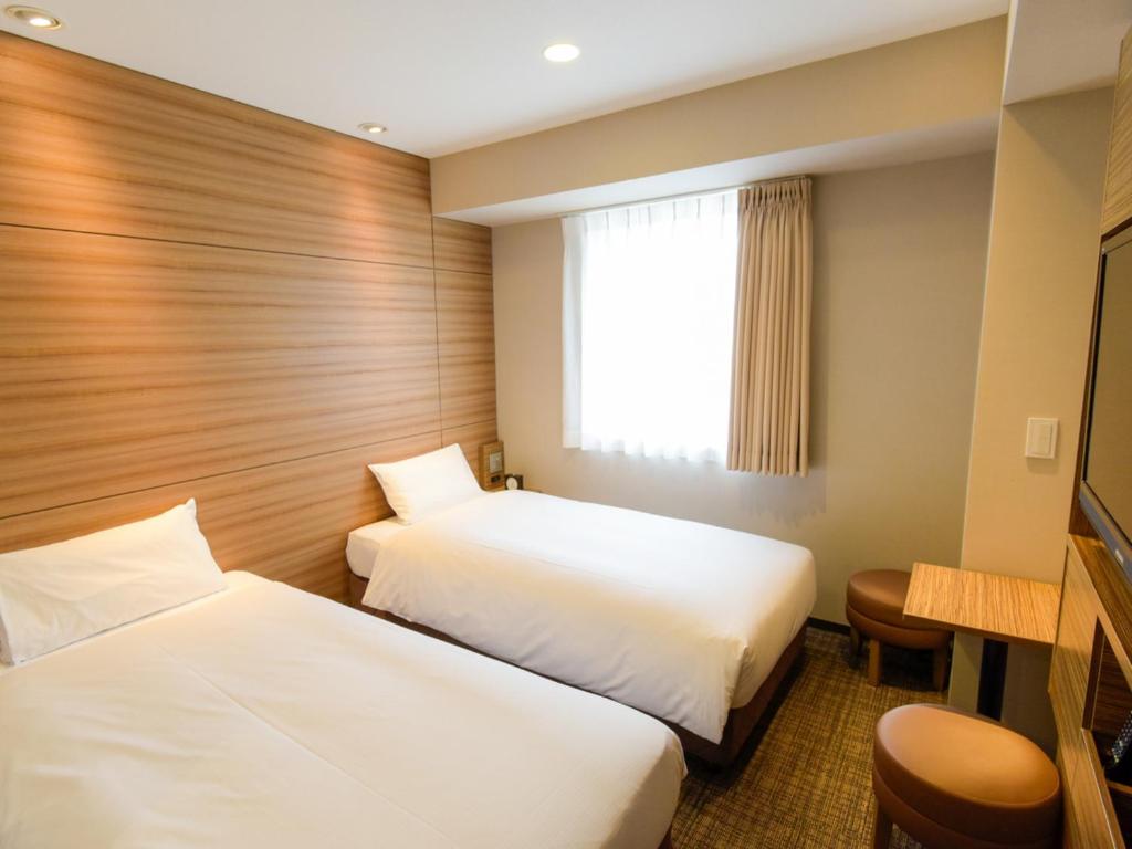 Postel nebo postele na pokoji v ubytování Via Inn Nagoya Shinkansen-guchi