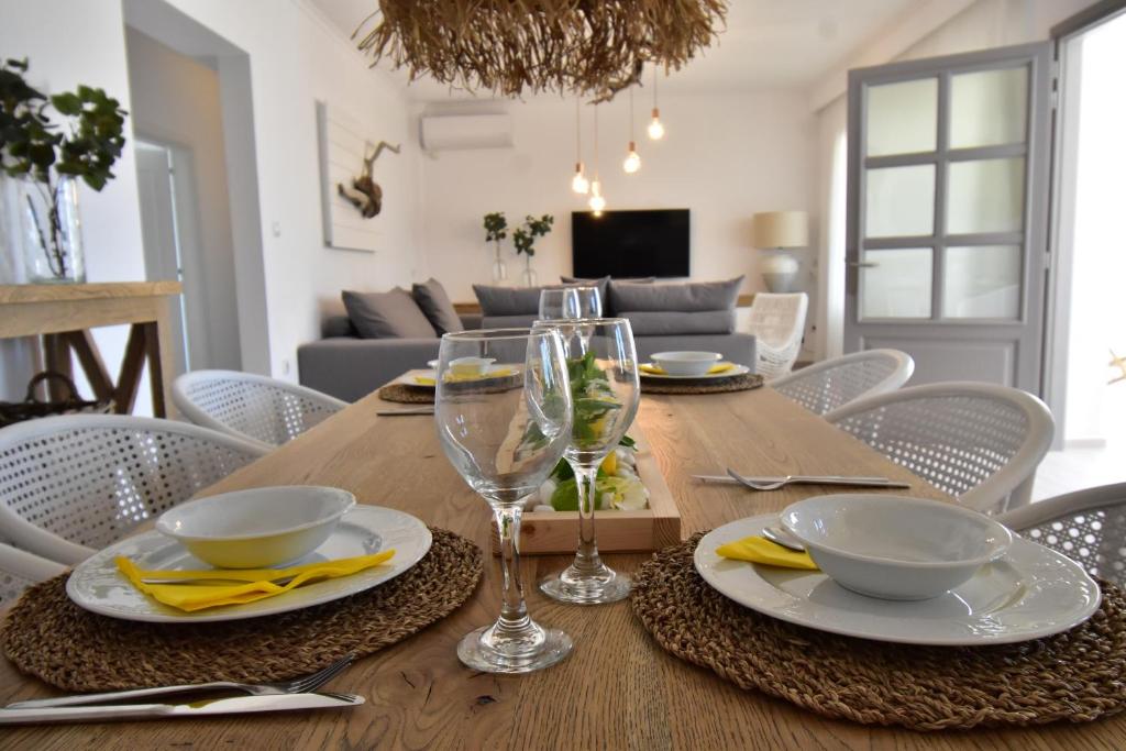 a wooden table with chairs and a dining room at Harmony Villa in Karpathos Town