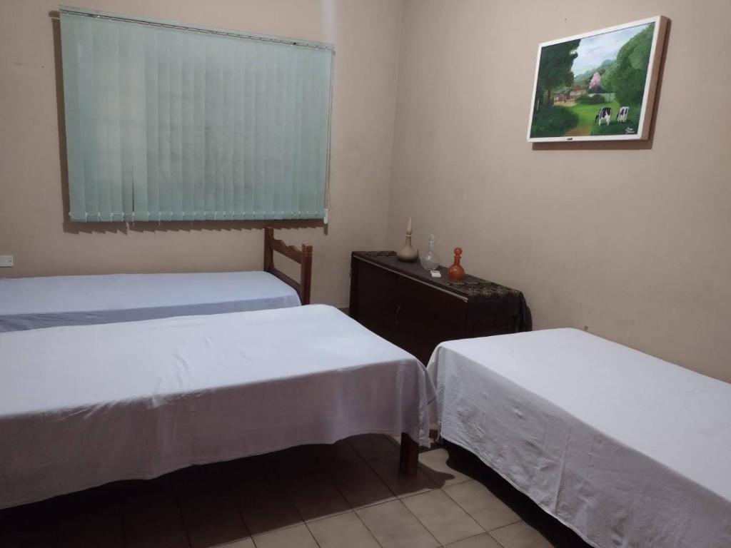 A bed or beds in a room at Pousada Recanto Alaketu Hospedagens