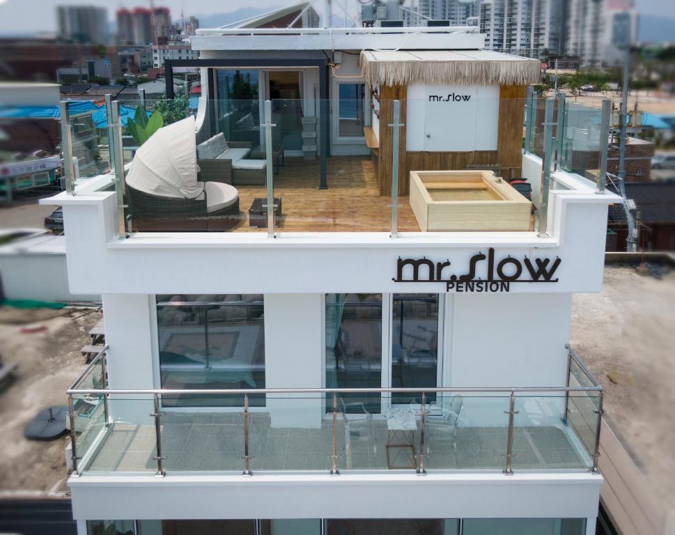 a white boat with a sign on the top of it at Mr. Slow in Sokcho