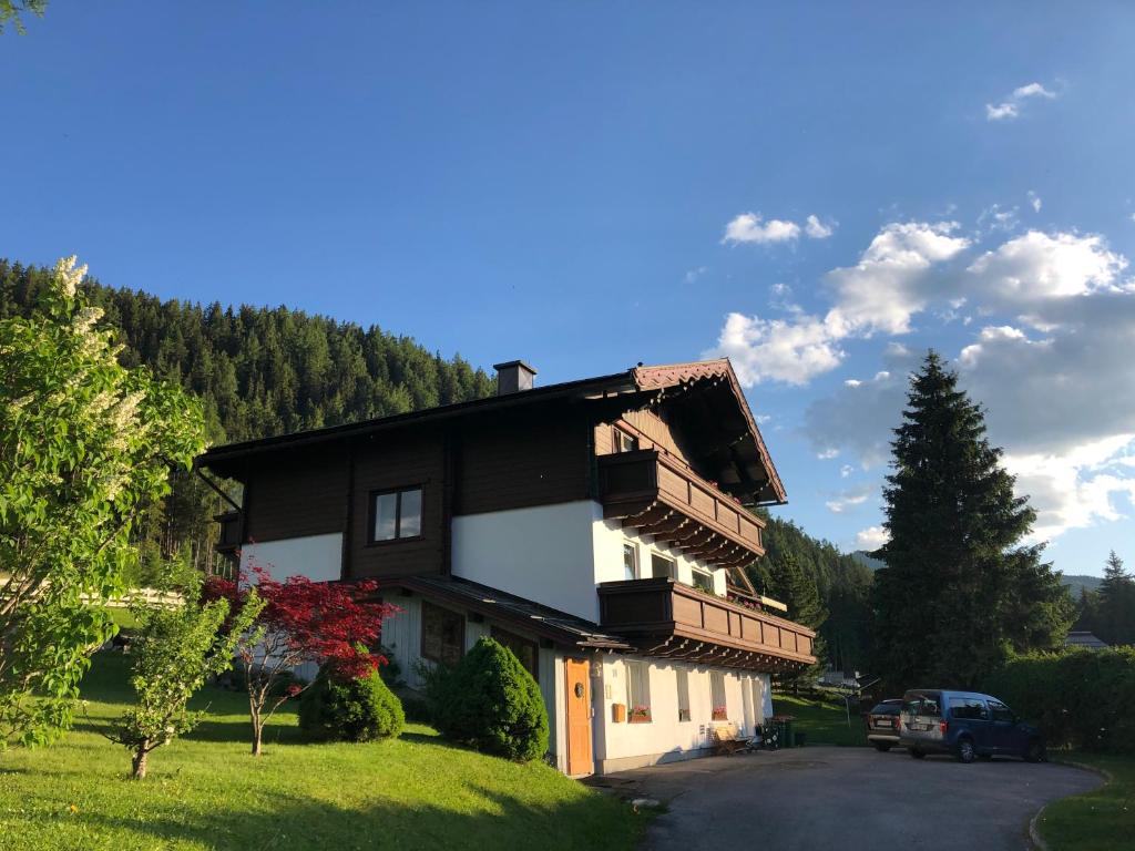a house with a car parked in front of it at Appartements Wilma in Schladming