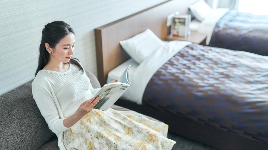 Postel nebo postele na pokoji v ubytování Kyoto Daiichi Hotel