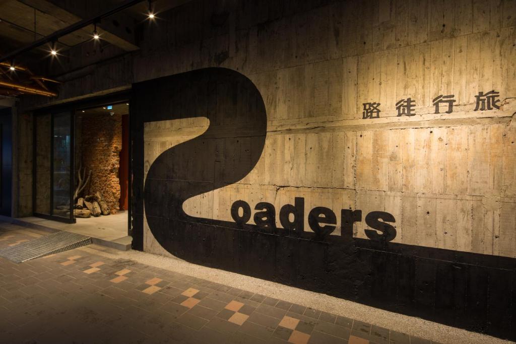 a sign on the side of a building that says adheres at Roaders Hotel - Zhonghua in Taipei