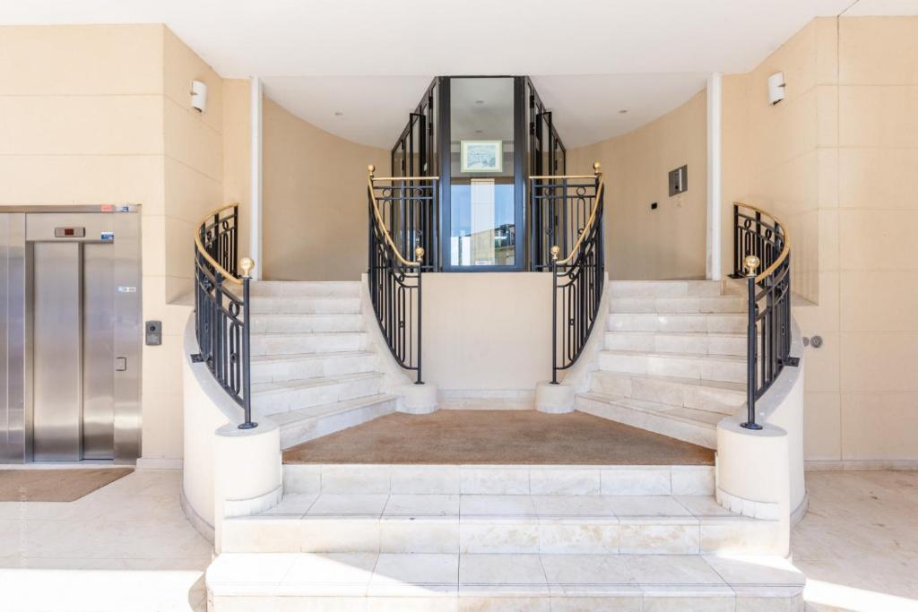 a lobby with stairs and a revolving door at Earth Center by Plaza - Proche Disneyland Paris in Chessy