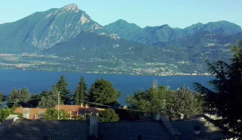 a view of a lake and mountains from a house at Warm, nice & amazing Lake-view apartment in San Zeno di Montagna