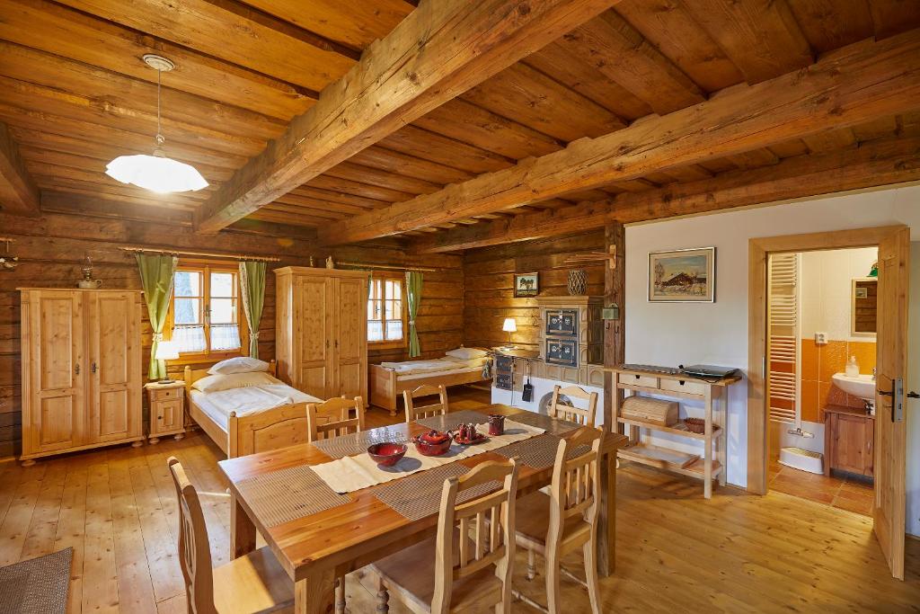 a kitchen and dining room with a table in a cabin at Volarská roubenka in Volary
