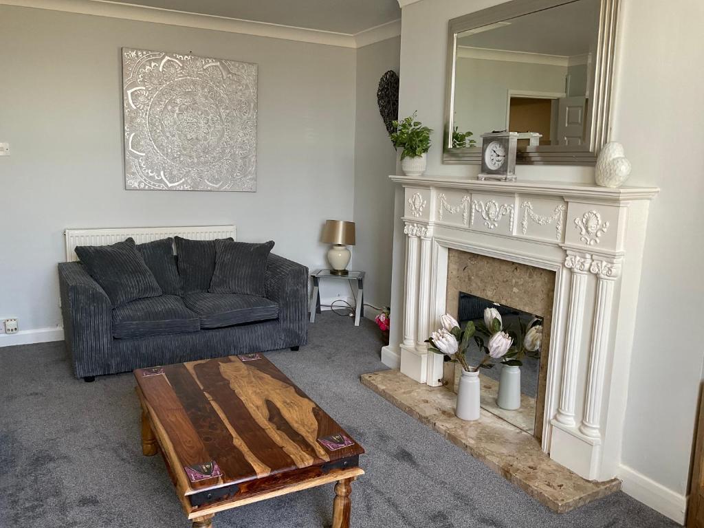 a living room with a couch and a fireplace at Seafront, Cleethorpes apt’s in Cleethorpes