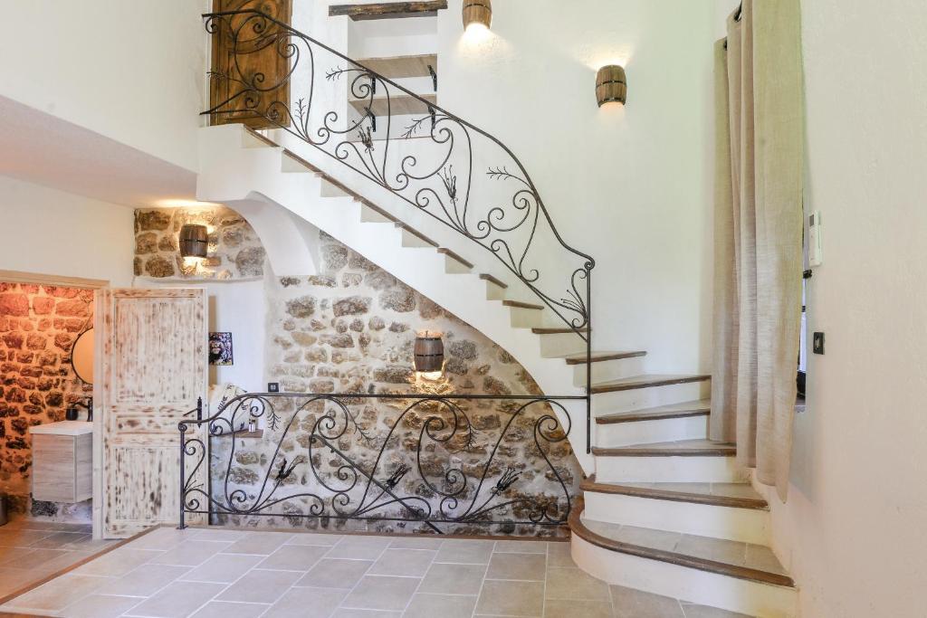 a spiral staircase in a home with a stone wall at Lovely apartment in Saint-Paul-De-Vence in Saint Paul de Vence