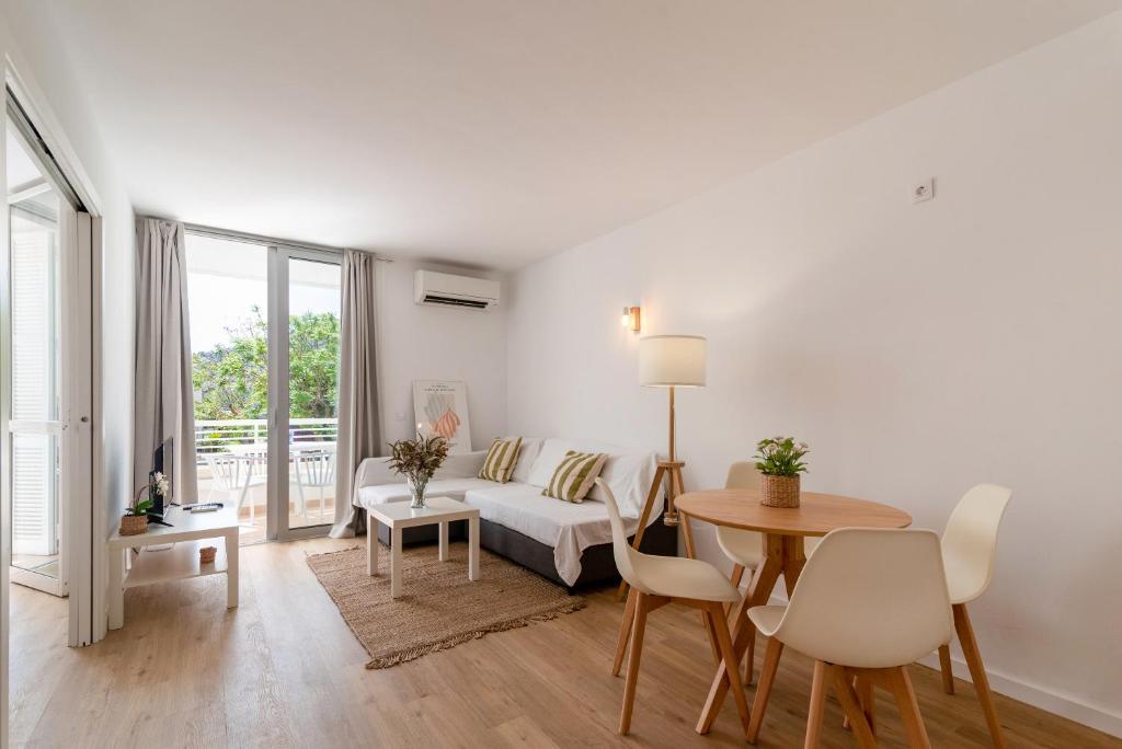 a living room with a couch and a table at Bellamar Apartments in Port d'Alcudia