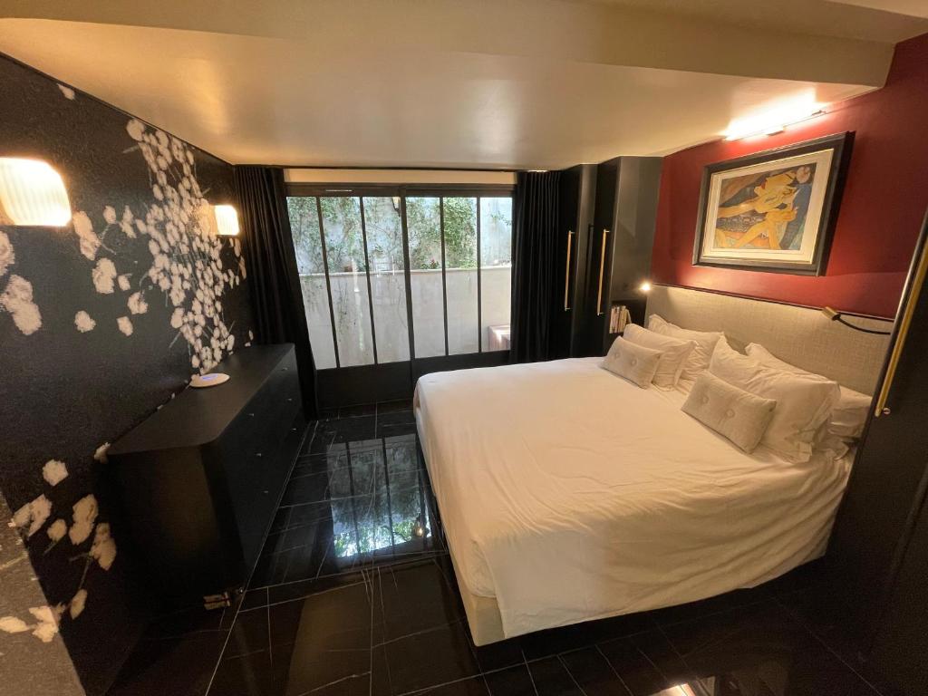 a bedroom with a white bed and a window at Villa Amara in Aix-en-Provence