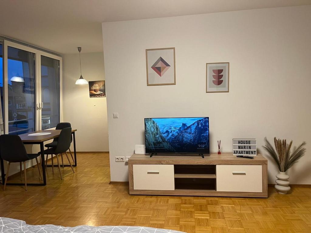 a living room with a flat screen tv on a table at House Marin II - Apartment in Maribor