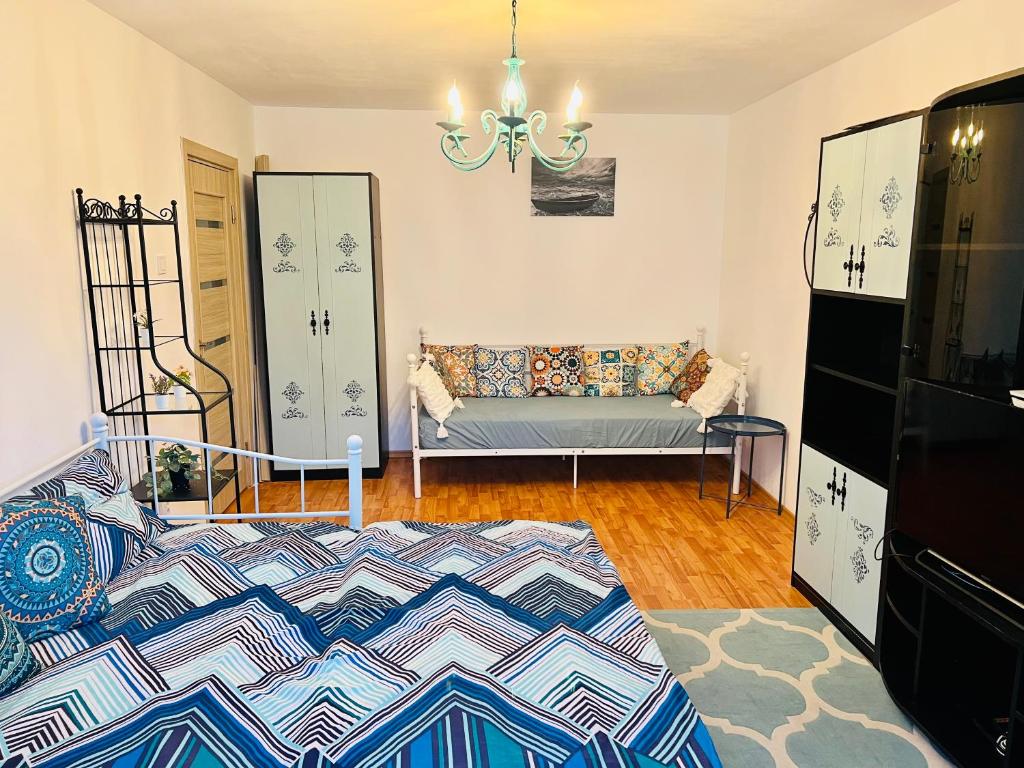 a living room with a couch and a chandelier at By The Sea for Family in Mangalia