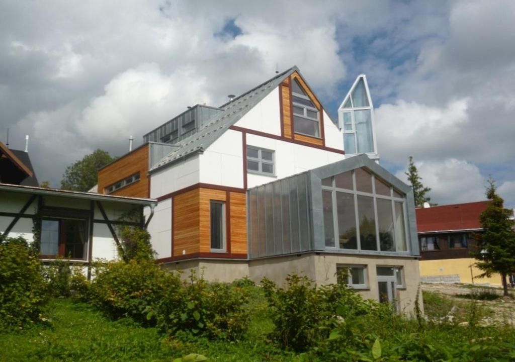 a house with a steep roof on top of it at Vila Lieska in Vysoke Tatry - Novy Smokovec