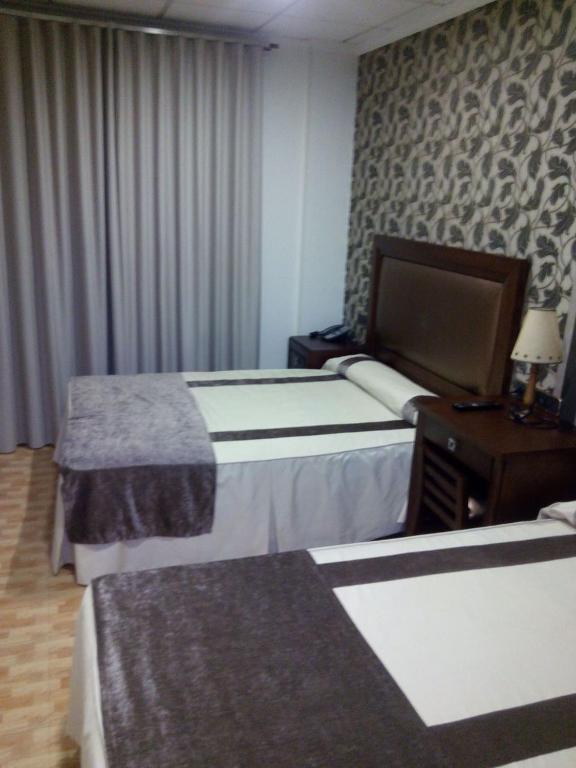 Postel nebo postele na pokoji v ubytování Hotel Julián