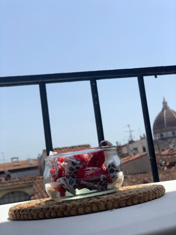 a glass bowl filled with toys sitting on a window sill at Short Stop Room in Florence