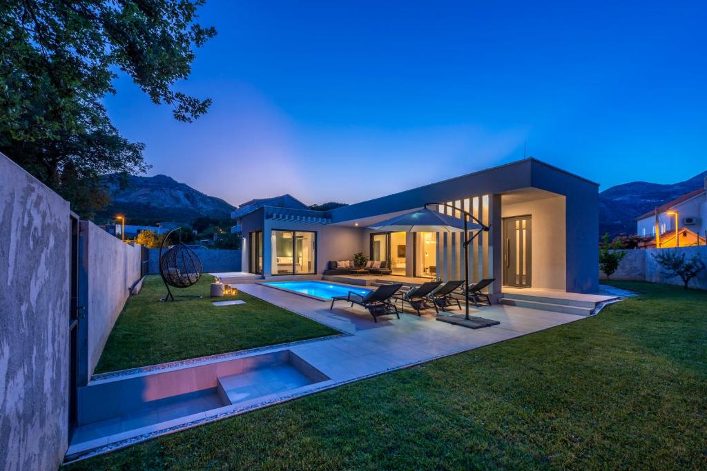 eine Villa mit einem Pool in der Nacht in der Unterkunft Villa Oasis - Your luxury home away from home in Lazine