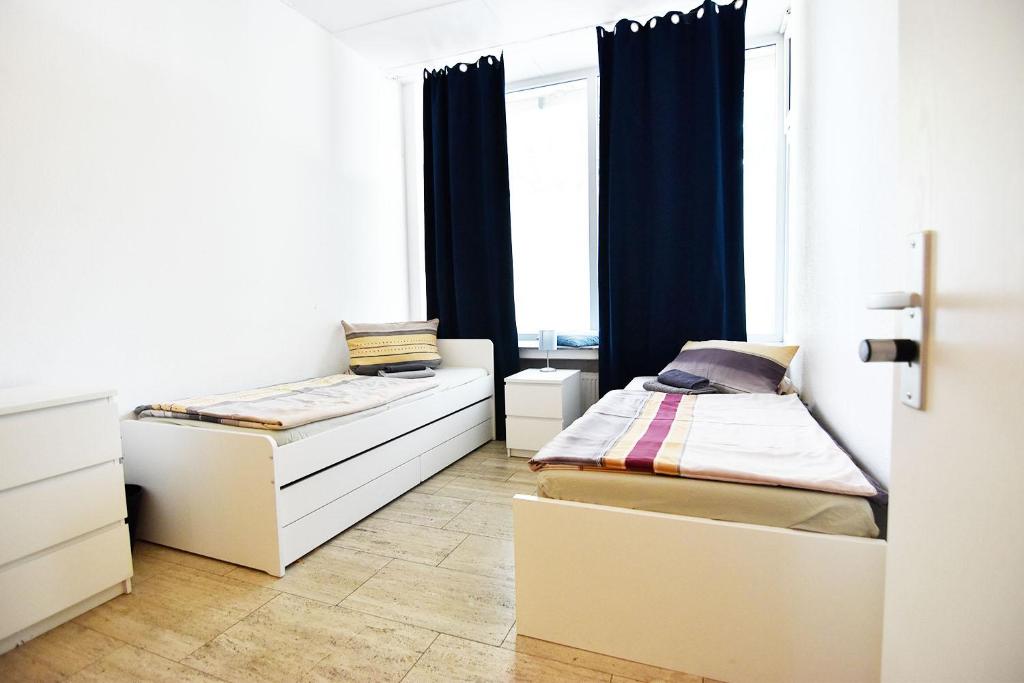 a bedroom with two beds and a window at Boardinghouse in Cologne *free WiFi* in Cologne