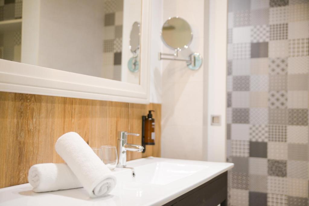 a bathroom with a white sink and a mirror at Lloret Vibe Affiliated by FERGUS in Lloret de Mar
