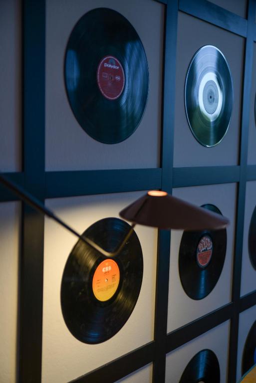a room with two records on a wall at Lloret Vibe Affiliated by FERGUS in Lloret de Mar