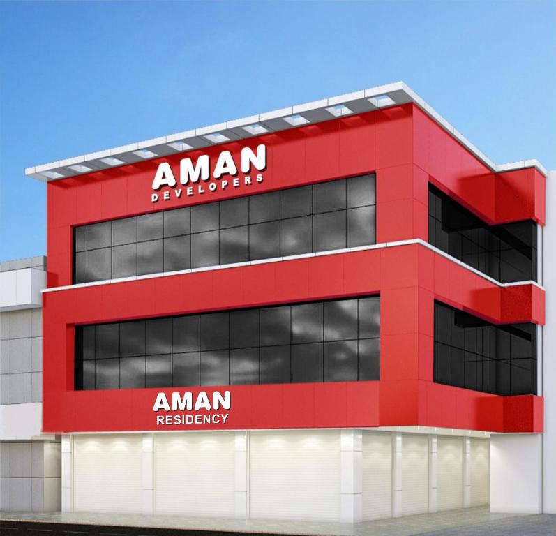 a red building with a aman headquarters at Aman Residency in Thodupuzha