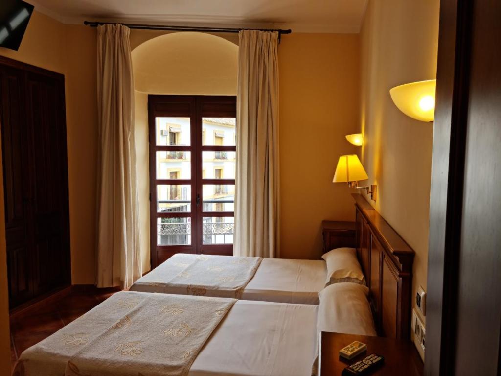 Postel nebo postele na pokoji v ubytování Hotel Plateros