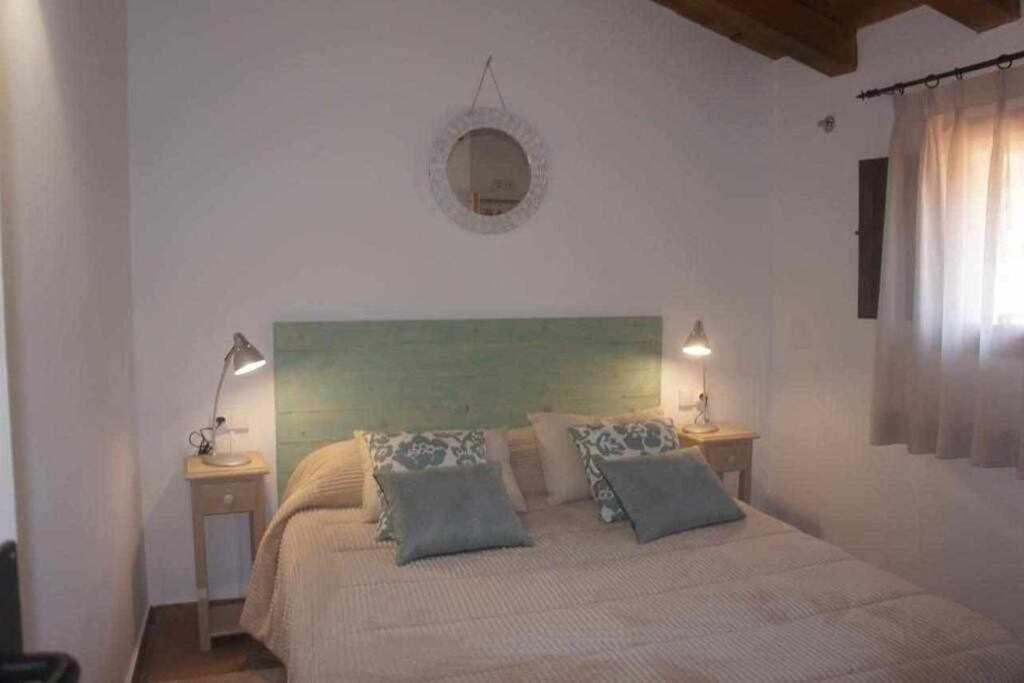 a bedroom with a large bed with two night stands at Rubielos de Mora Ollerías in Rubielos de Mora