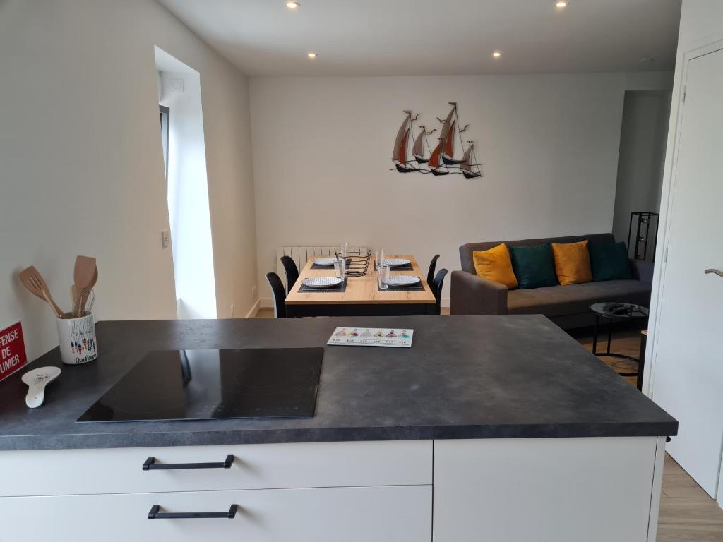 a kitchen with a counter top and a living room at Ker Kiberen in Quiberon