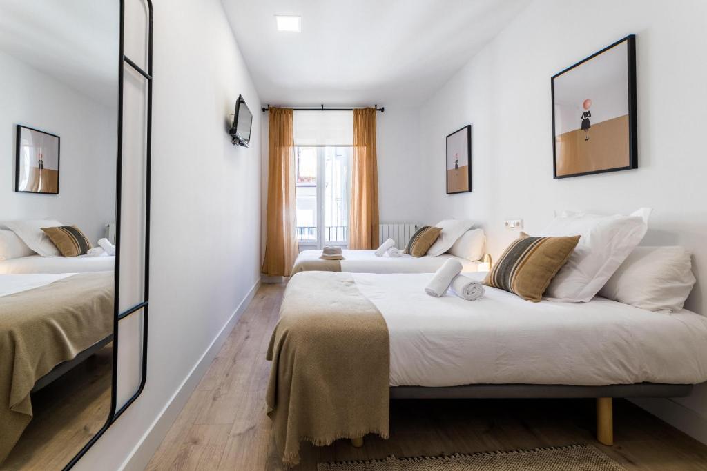 Posteľ alebo postele v izbe v ubytovaní GETARIA by SWEET HOME SAN SEBASTIAN