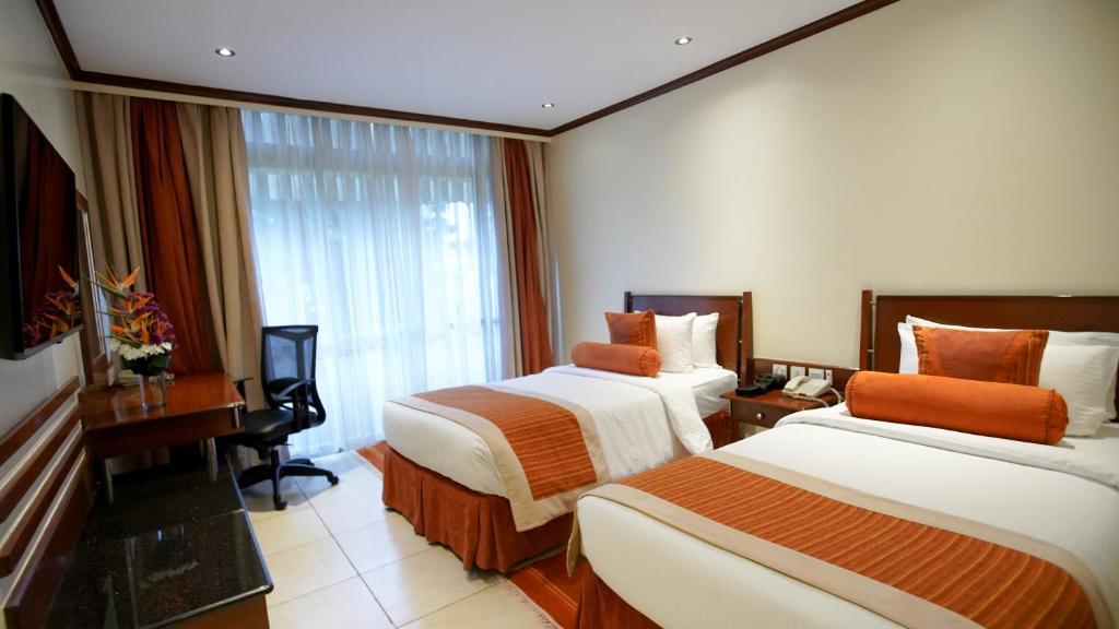 Postel nebo postele na pokoji v ubytování Sarova Panafric Hotel