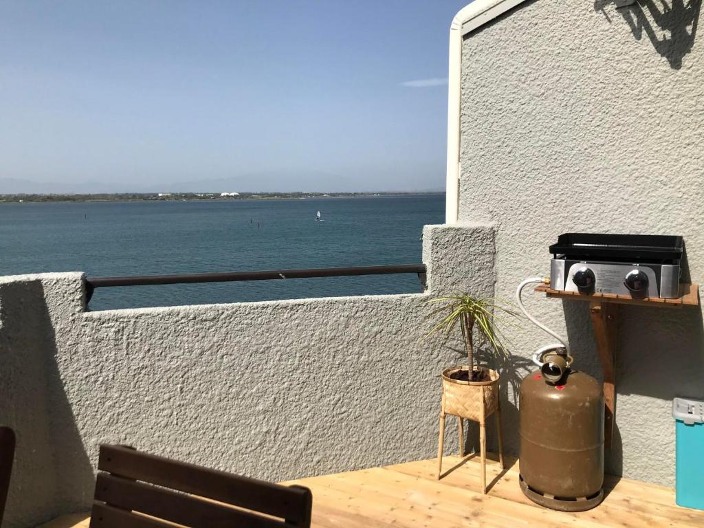 a balcony with a view of the water at Ile du Cap Couladère - Vue magnifique lac marin - Baignoire Jaccuzi - Complexe piscine, sportif, animations in Le Barcarès