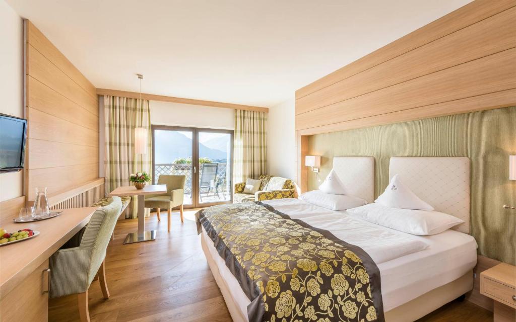 Postel nebo postele na pokoji v ubytování Hotel Lagrein