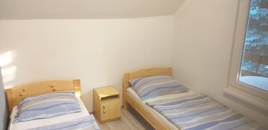 Posteľ alebo postele v izbe v ubytovaní Szépvölgyi Apartmanház