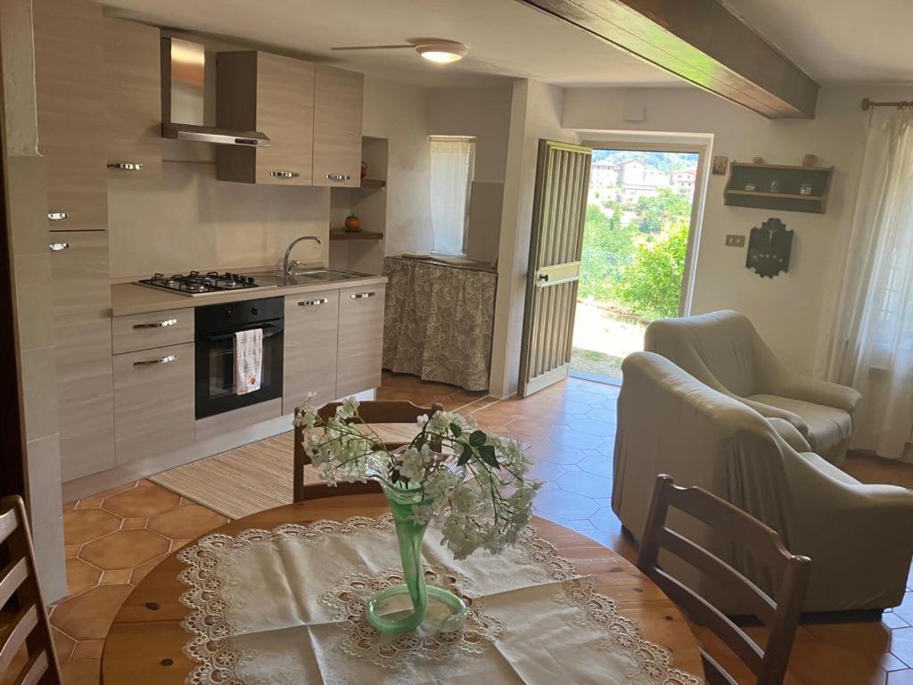 a kitchen with a table with a vase on it at Bellavista Cascianella in Piazza al Serchio