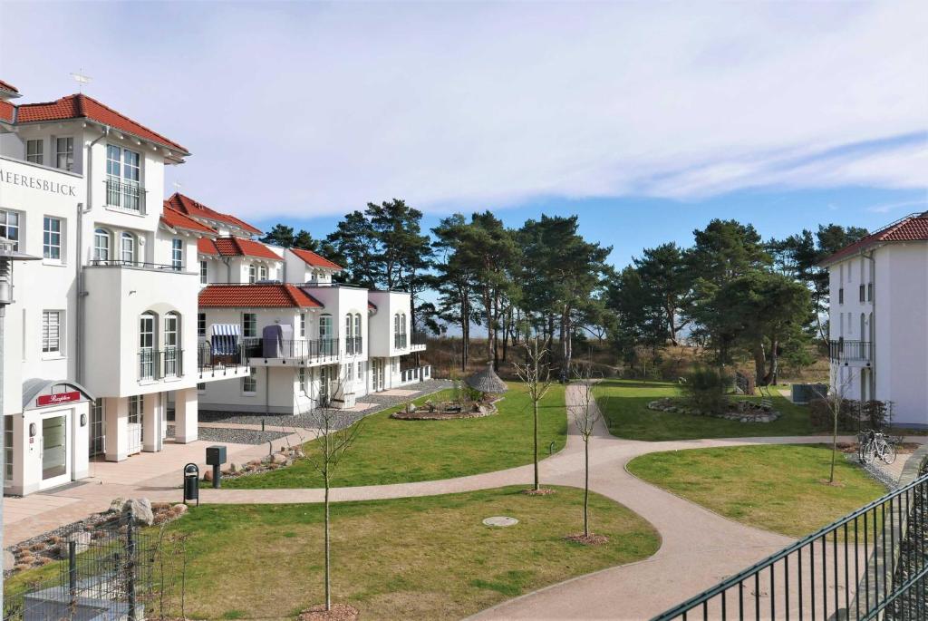 a walkway through a town with houses at Haus Meeresblick - Ferienwohnung Strandnah A 1.07 (Ref. 128675) in Baabe