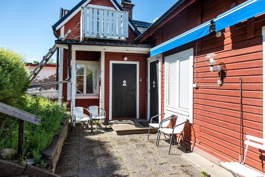 a porch of a house with chairs and a door at Holiday apartment in Vimmerby with cozy courtyard in Vimmerby