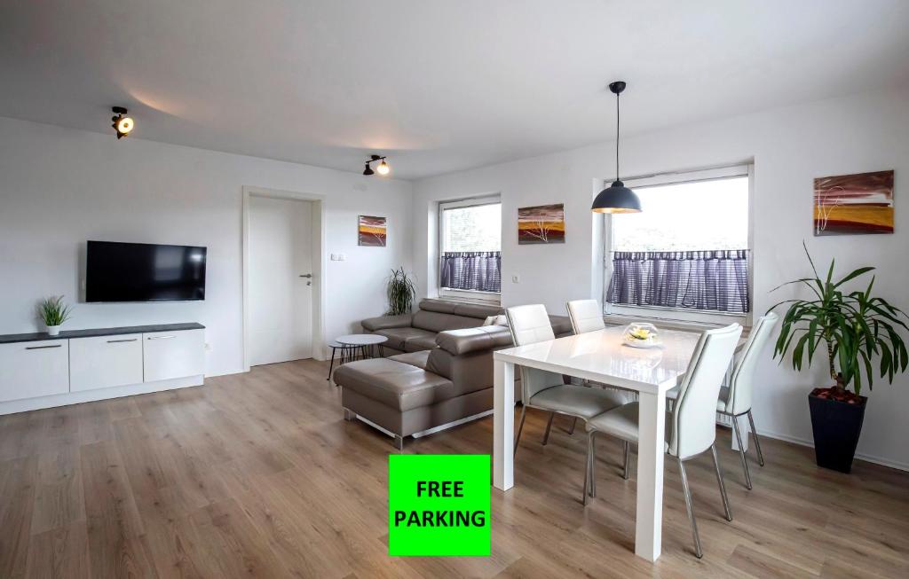 a living room with a table and a couch at Apartments Vila Apolonia in Ljubljana