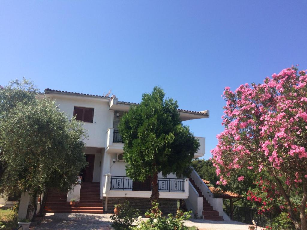 a house with pink flowers in front of it at Sofia Villa in Astris