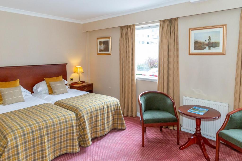 Postel nebo postele na pokoji v ubytování Alexandra Hotel