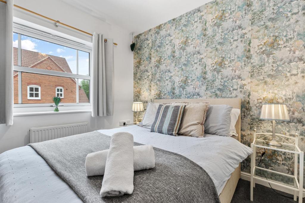 a bedroom with a large bed and a large window at Modern 2-BR Home WiFi plus Parking in Thringstone