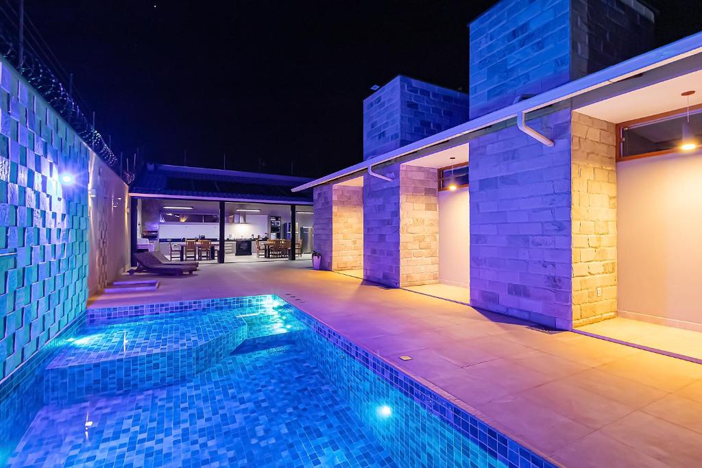 a swimming pool in a house at night at casa torre de pedra in Pirenópolis