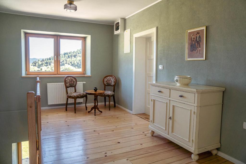 a room with a table and chairs and a window at Holiday Home Lož in Stari Trg pri Ložu