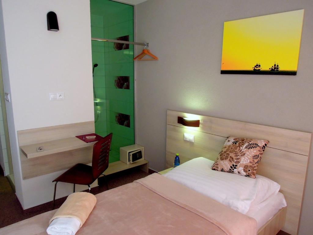 Postel nebo postele na pokoji v ubytování Hotel Kristína