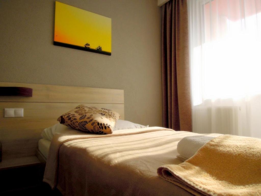 Postel nebo postele na pokoji v ubytování Hotel Kristína