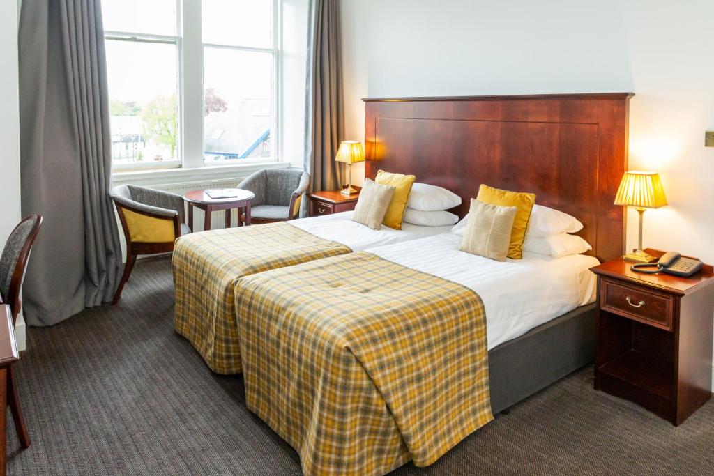 Postel nebo postele na pokoji v ubytování Alexandra Hotel