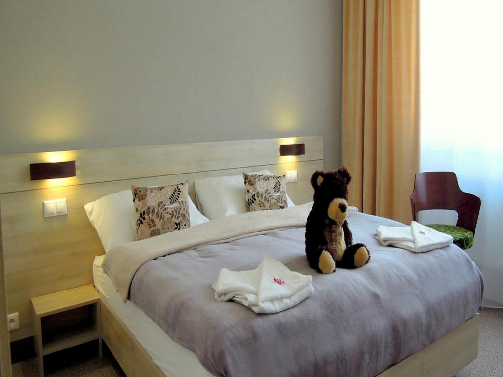 Postel nebo postele na pokoji v ubytování Hotel Kristína