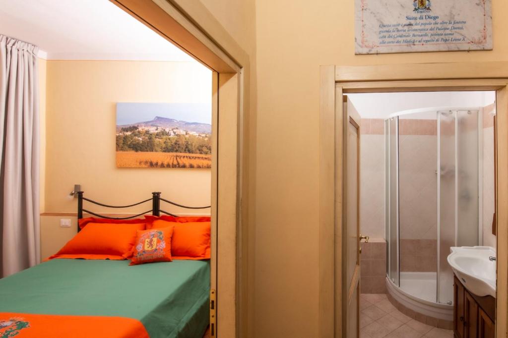 a bedroom with a bed and a sink and a mirror at IBibiena - SUITE DI DIEGO in Bibbiena