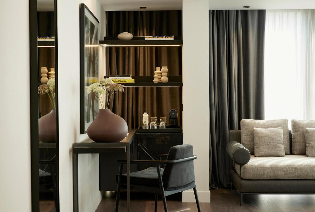 a living room with a desk and a chair at Teight Hotel in Thessaloniki