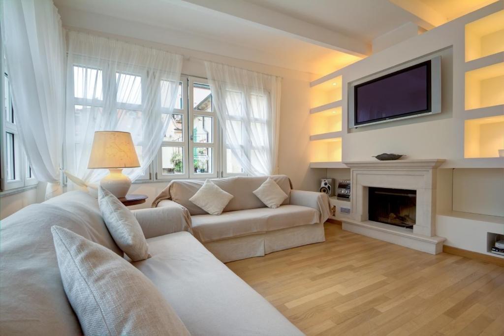 a living room with a couch and a fireplace at Alassio bnb Apartments in Alassio